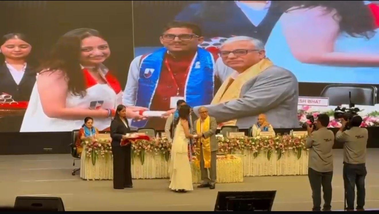 Aayushi Parmar receiving recognition on stage